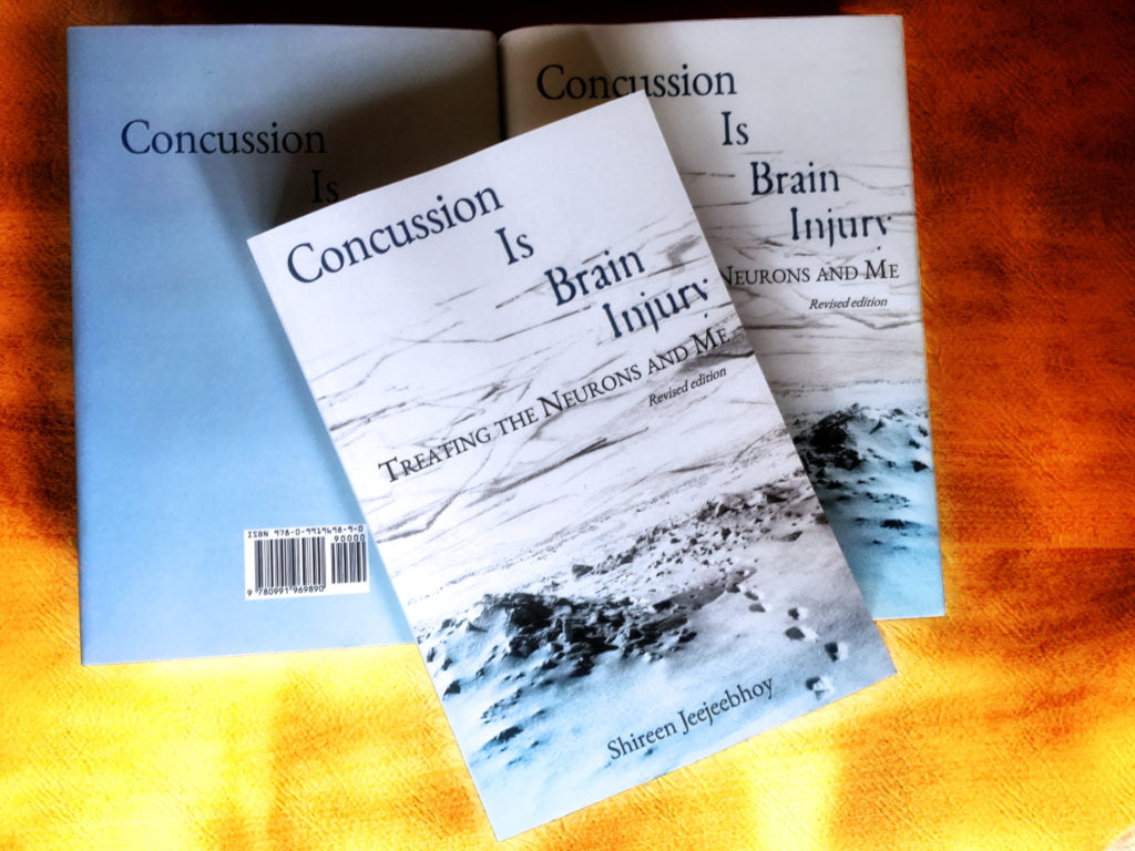 My just delivered paperback and hard covers of Concussion Is Brain Injury in their pretty blue-and-white jackets.