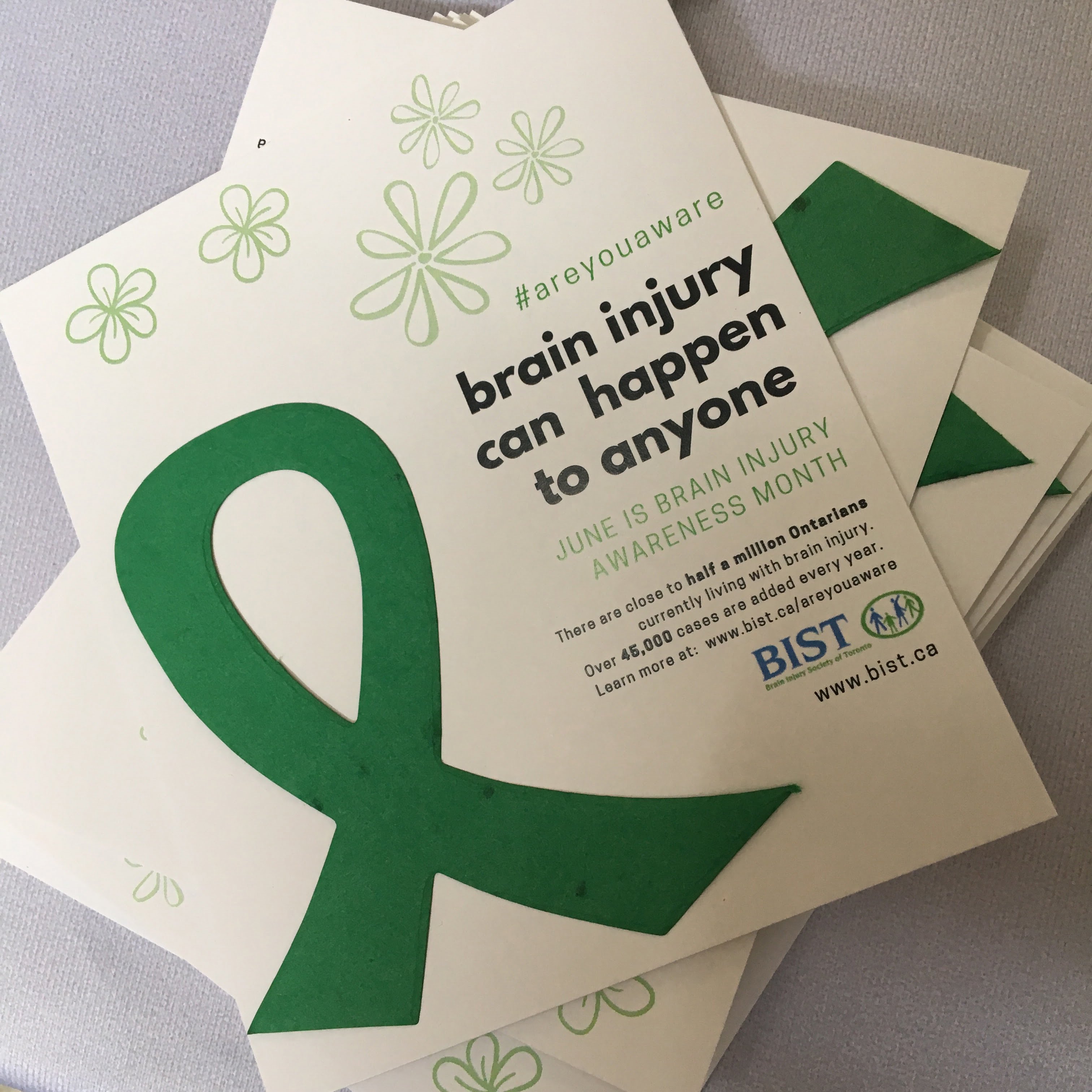 Green brain injury seed ribbon with stats on card