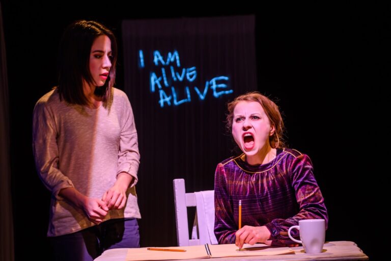 Brain storm photo of two women, one seated, one standing and looking down at her yelling with the words behind "I am alive. Alive"